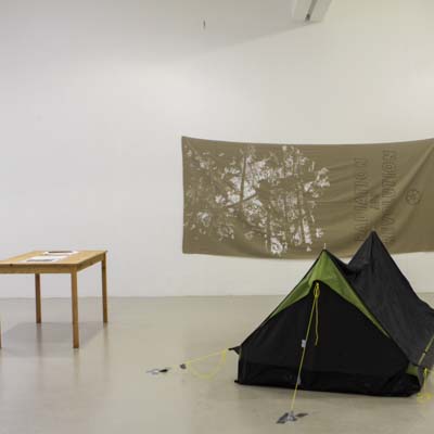 image of a Tent and table with a banner on wall